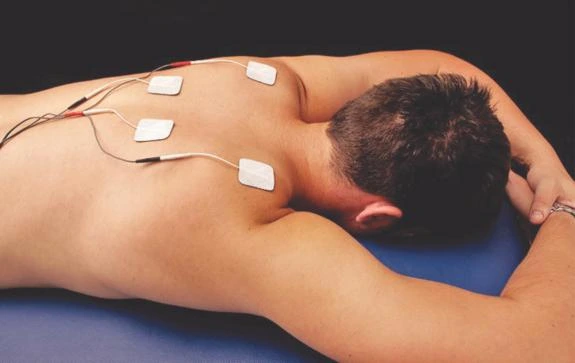 Modern electrotherapy clinic setup with digital modalities and treatment bay in a clean physiotherapy environment