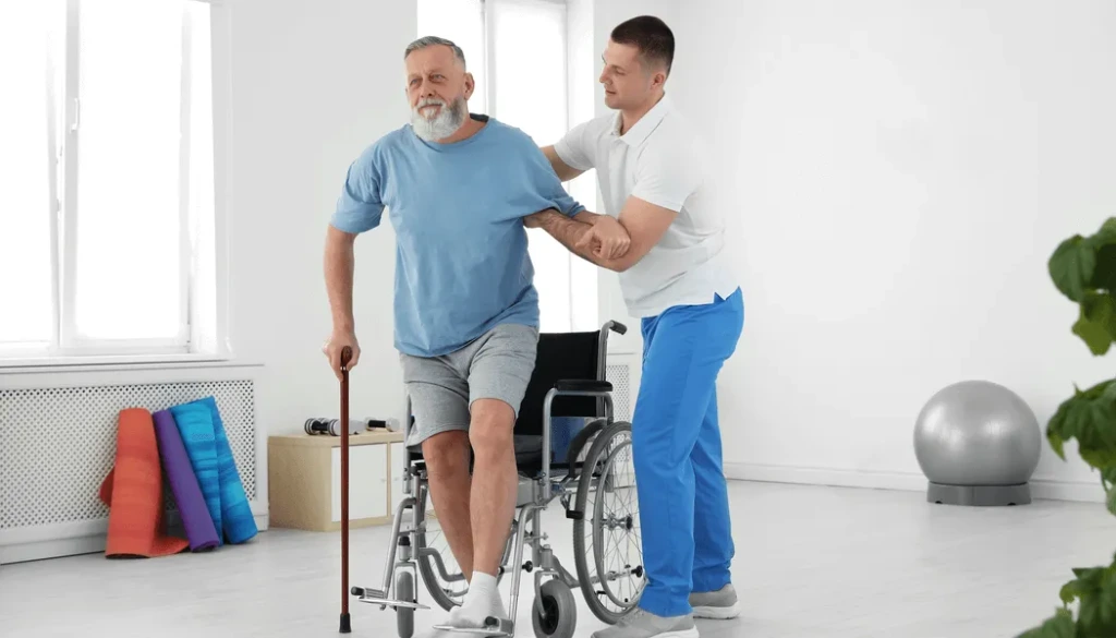 Professional physiotherapist assisting a patient with functional movement and transfer training